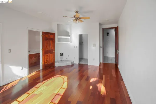 wooden floor in an empty room with a window
