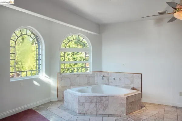 a bath tub sitting in a bathroom next to a window