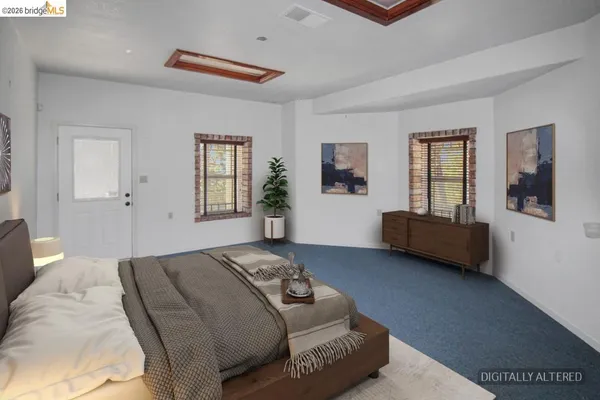 a bedroom with a bed and a couch