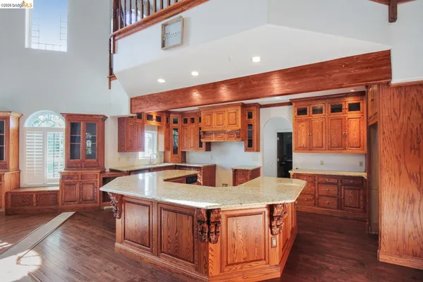 a kitchen with stainless steel appliances granite countertop a stove and a wooden floors