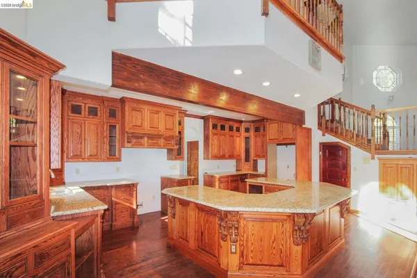 a kitchen with stainless steel appliances granite countertop a sink a stove and a refrigerator