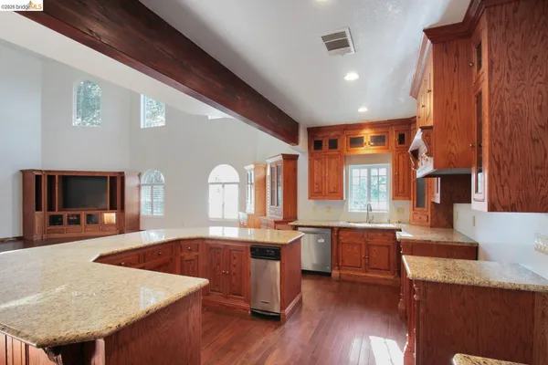 a kitchen with granite countertop a sink counter top space and cabinets
