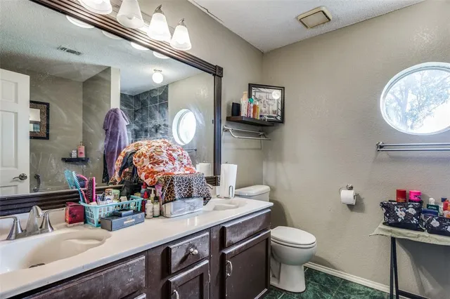 a bathroom with a toilet a sink and a mirror