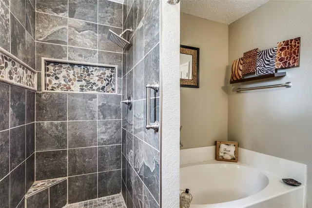a bathroom with a bathtub and shower