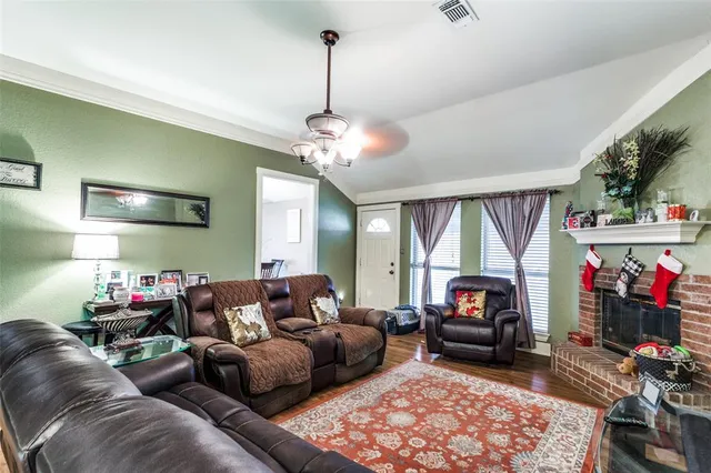a living room with furniture fireplace and a window