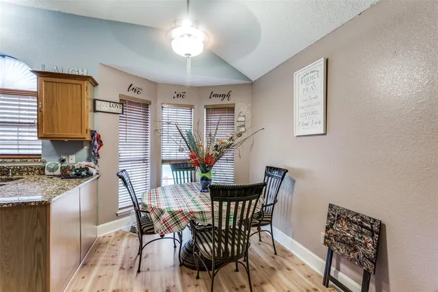 a view of a dining room with furniture and a chandelier