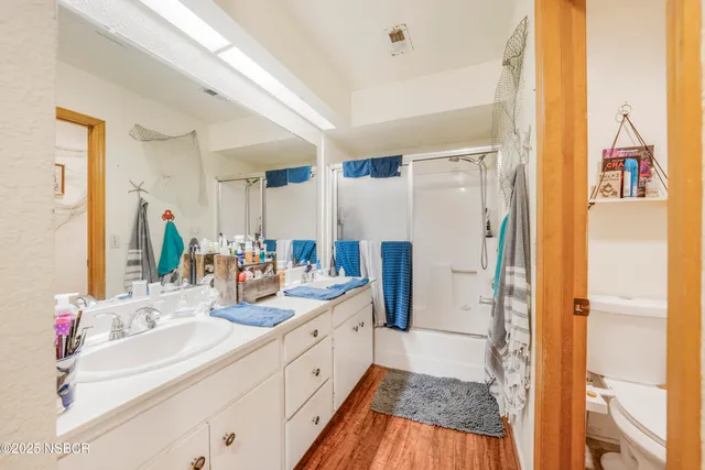 a bathroom with a sink a mirror and a shower