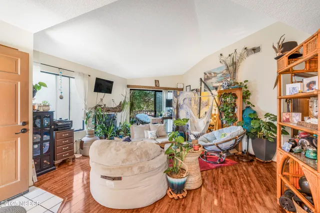 a living room with furniture and flowers