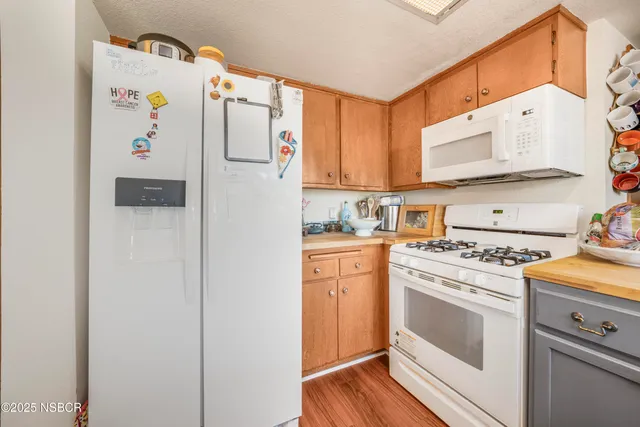 a white refrigerator freezer sitting inside of a kitchen