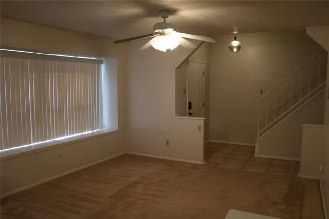 a view of an empty room with stairs