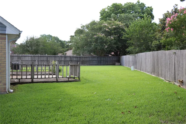 a view of a backyard with a fence