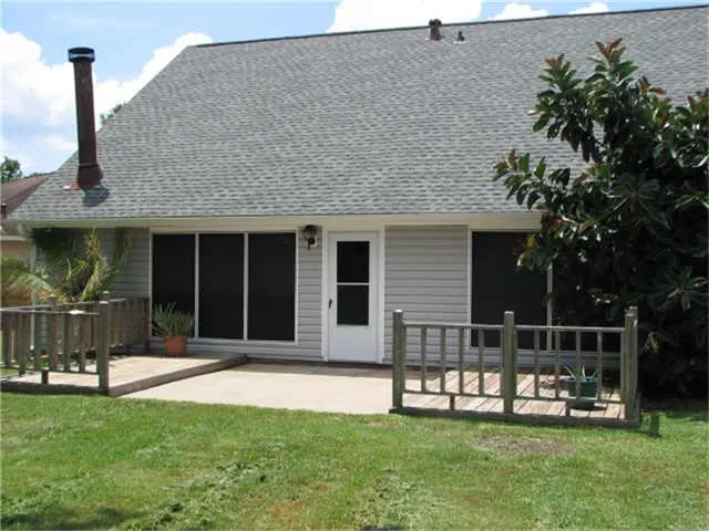 a front view of a house with a yard table and chairs