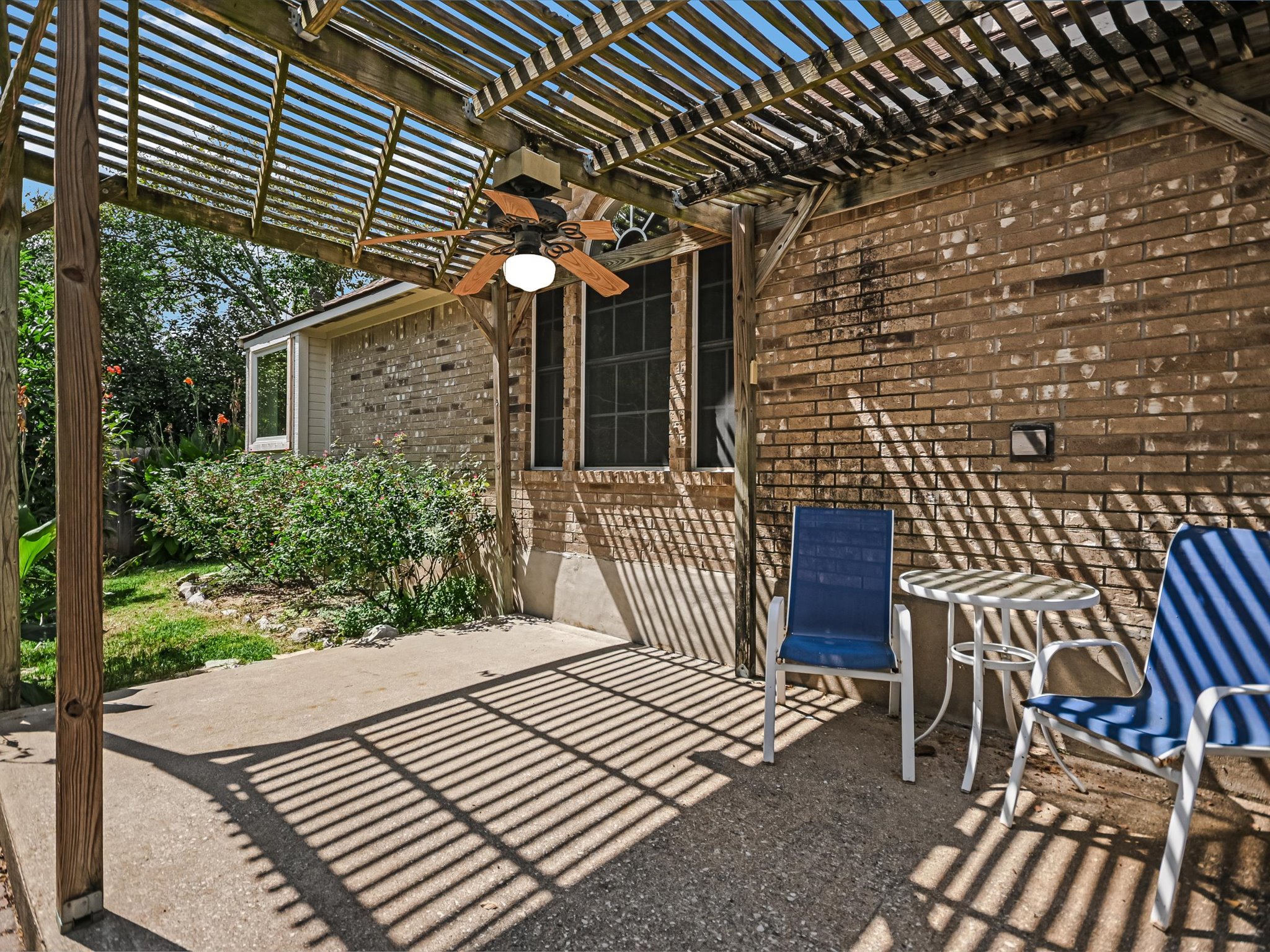 10817 Redmond Road Austin, TX 78739 - Photo 17 of 21 Step outside to a pergola covered patio and fully fenced backyard with room to relax, entertain, or create your dream outdoor retreat with the greenbelt as your backdrop.