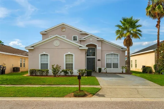 a front view of a house with a garden and plants