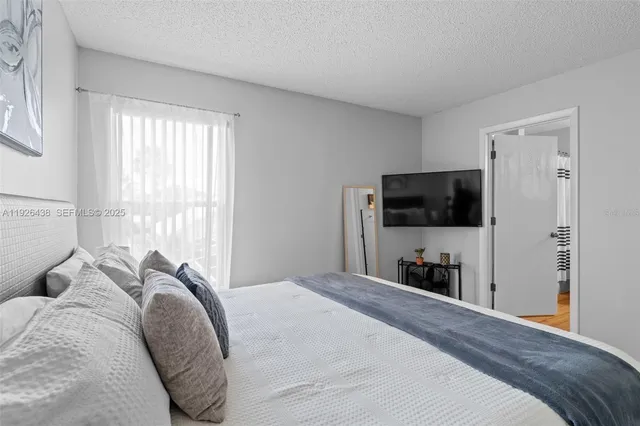 a bathroom with a sink a toilet and shower curtain
