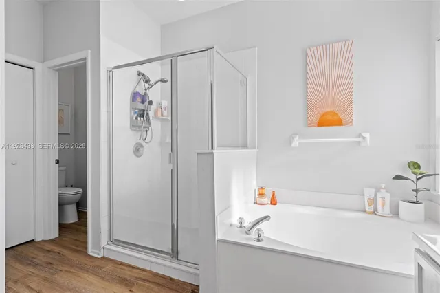 a bathroom with a double vanity sink mirror and bathtub
