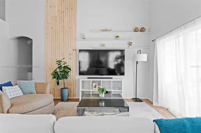 a living room with furniture and a potted plant