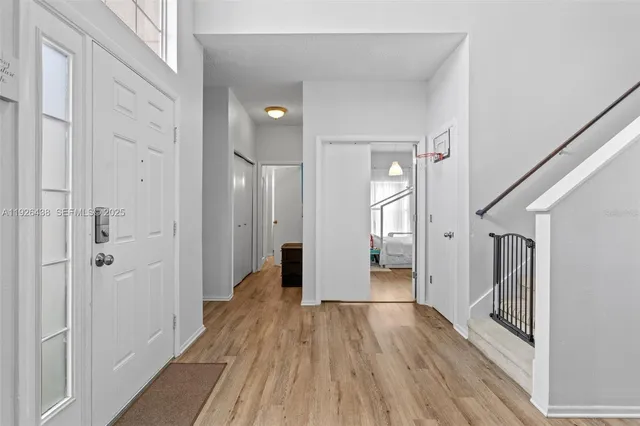a view of a hallway with wooden floor and staircase