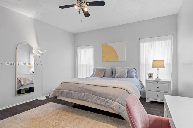 a bedroom with a bed couch and window