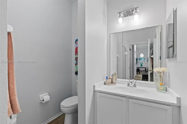 a bathroom with a sink toilet and a mirror