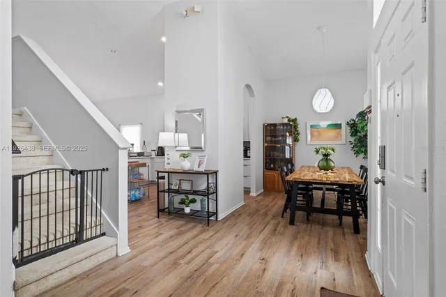 a dining room with furniture and wooden floor
