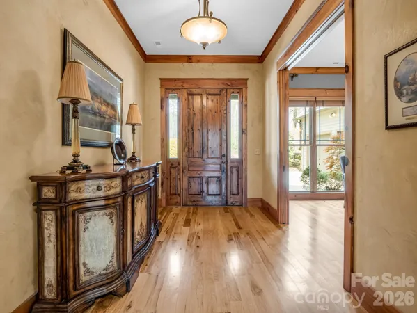 a living room with furniture large wooden floor and a fireplace