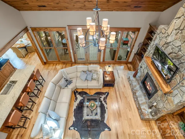 a living room with furniture and floor to ceiling windows