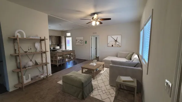 a living room with furniture and a chandelier