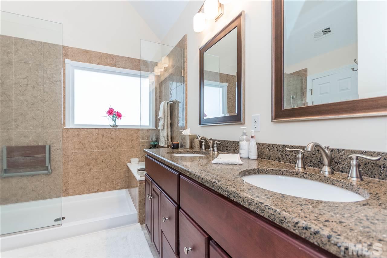 6020 Wild Orchid Trail Raleigh, NC 27613 - Photo 17 of 26 Beautifully and totally renovated master suite with granite double vanity and large walk in shower with seat.