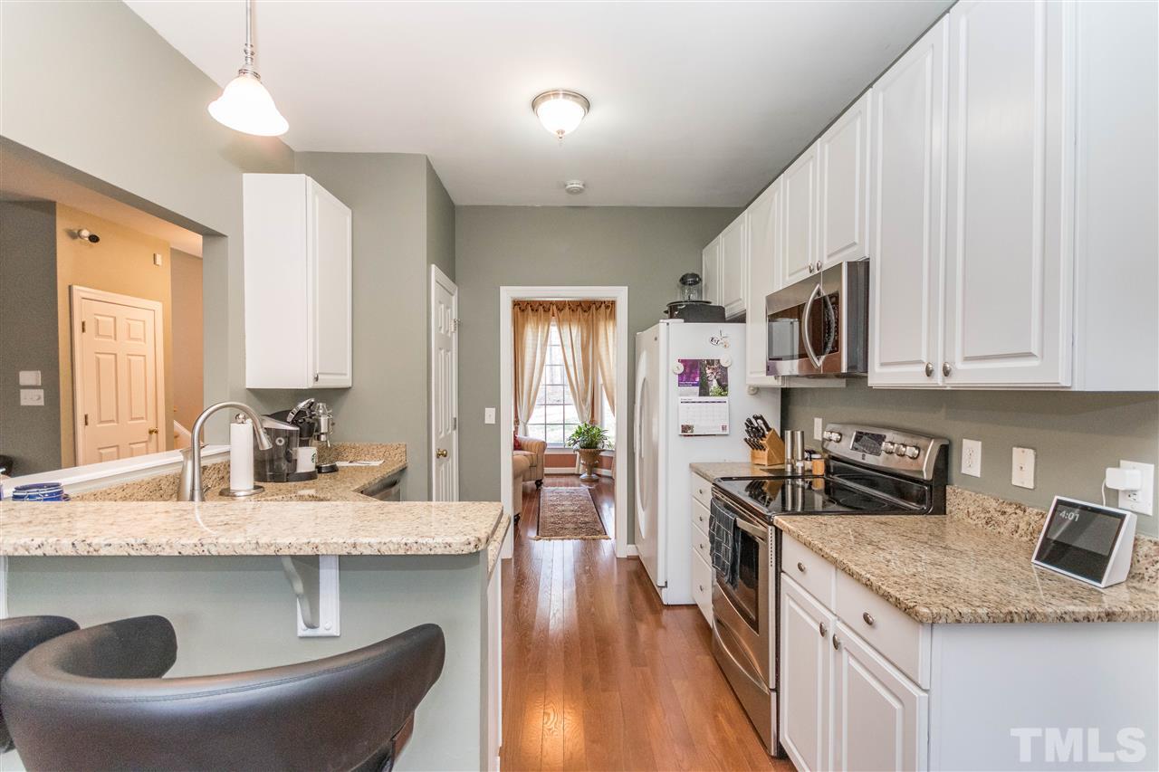 6020 Wild Orchid Trail Raleigh, NC 27613 - Photo 7 of 26 Kitchen with breakfast bar seating