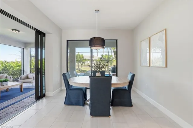 a dining room with furniture window and wooden floor