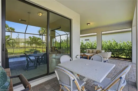 a living room with patio a table and chairs
