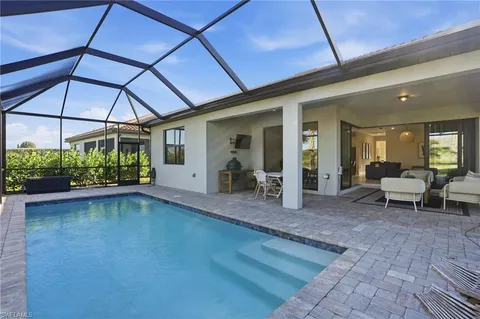 a view of a patio with table and chairs under an umbrella