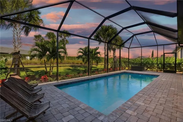 swimming pool view with a seating space