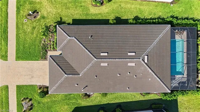 a aerial view of a house with a yard and potted plants