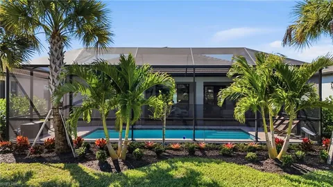 a house with lots of trees in front of it