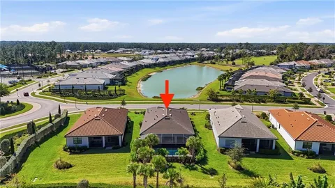 an aerial view of residential houses with outdoor space and ocean view