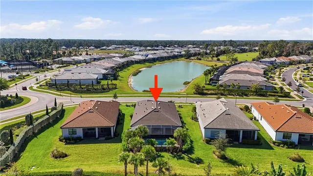 an aerial view of residential houses with outdoor space and ocean view