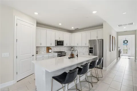 a kitchen with stainless steel appliances a stove refrigerator sink and cabinets