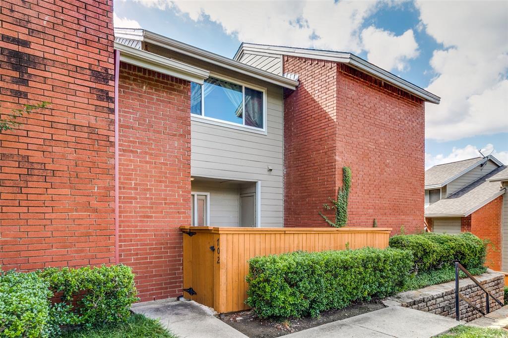 8404 Forest Lane, Unit 702 Dallas, TX 75243 - Photo 1 of 12 a view of front of house with a yard