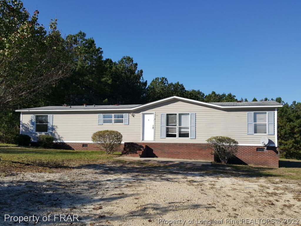 1113 Fire Lane Road Bunnlevel, NC 28323 - Photo 1 of 18 a front view of a house with garden