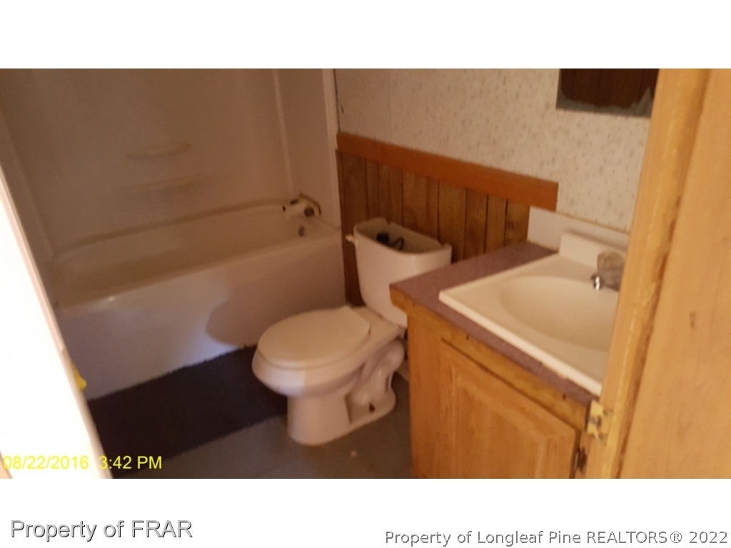 1113 Fire Lane Road Bunnlevel, NC 28323 - Photo 11 of 18 a bathroom with a toilet and a sink