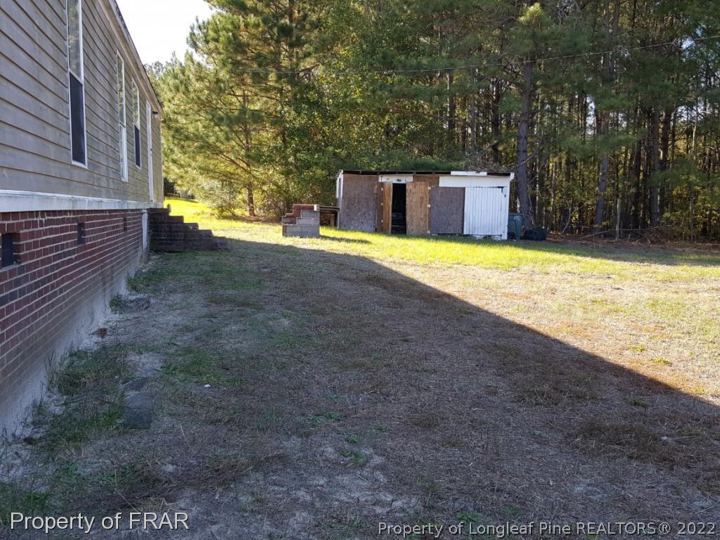 1113 Fire Lane Road Bunnlevel, NC 28323 - Photo 4 of 18 a view of a backyard with large trees