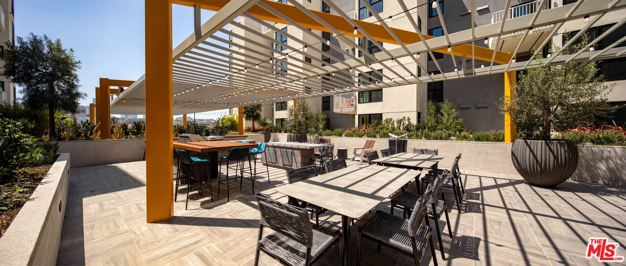 1101 North Main Street, Unit B326 Los Angeles, CA 90012 - Photo 23 of 35 a view of a patio with table and chairs and potted plants