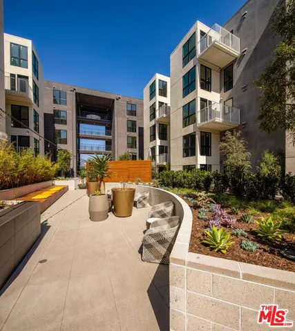 a view of a patio with a table and chairs