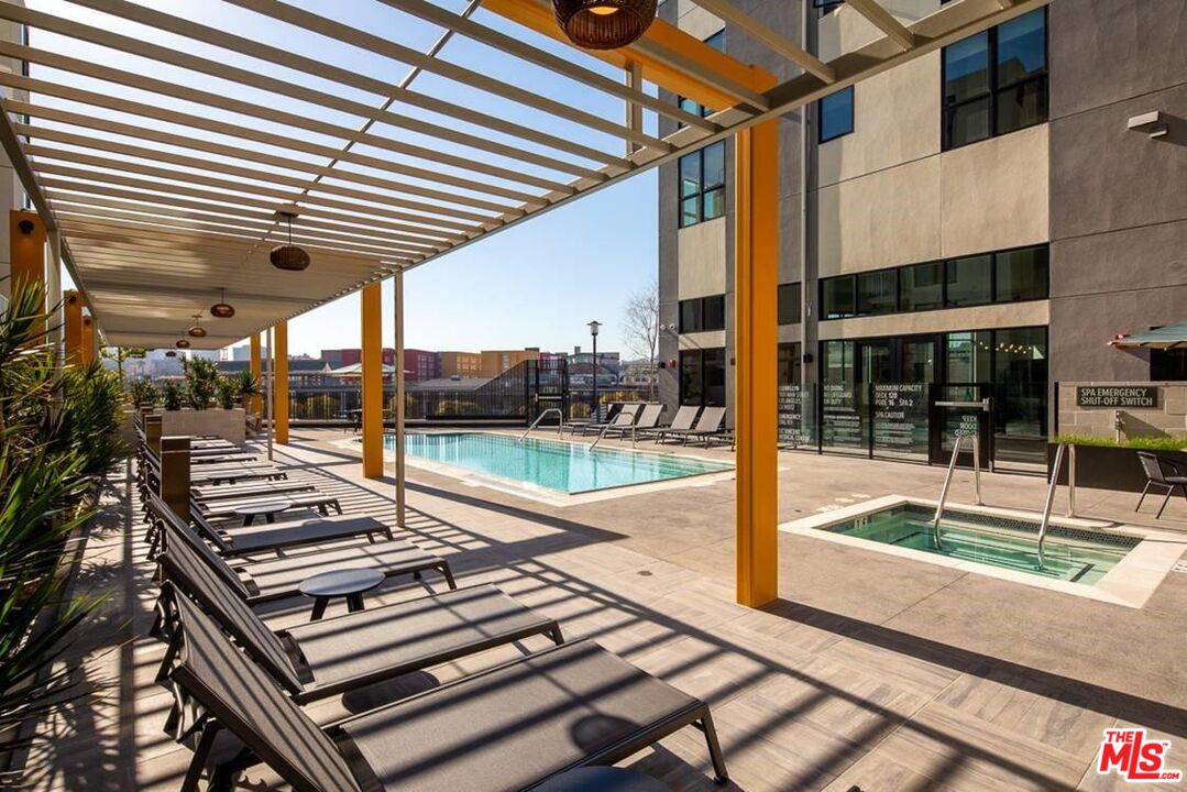 1101 North Main Street, Unit B326 Los Angeles, CA 90012 - Photo 33 of 35 a view of a patio with table and chairs with wooden floor and fence