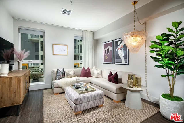 a bathroom with a sink a toilet a mirror a bathtub and shower