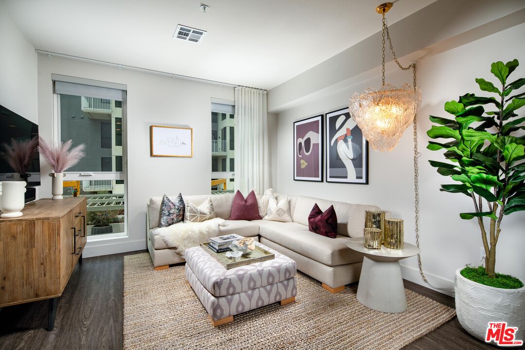 1101 North Main Street, Unit B326 Los Angeles, CA 90012 - Photo 6 of 35 a living room with furniture and a potted plant