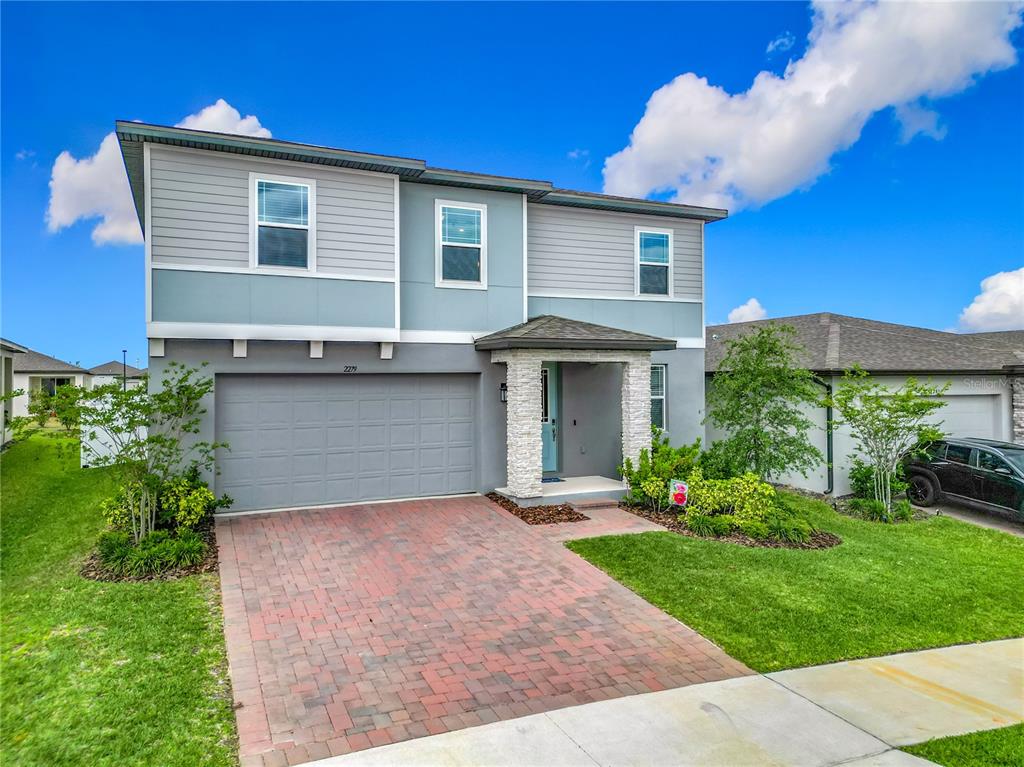 2279 Raven Rdg Drive Minneola, FL 34715 - Photo 1 of 1 a front view of house with yard and green space