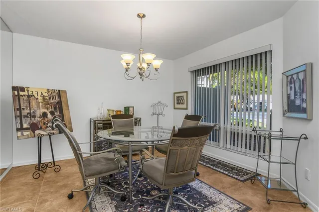 a view of a dining room with furniture a chandelier and wooden floor
